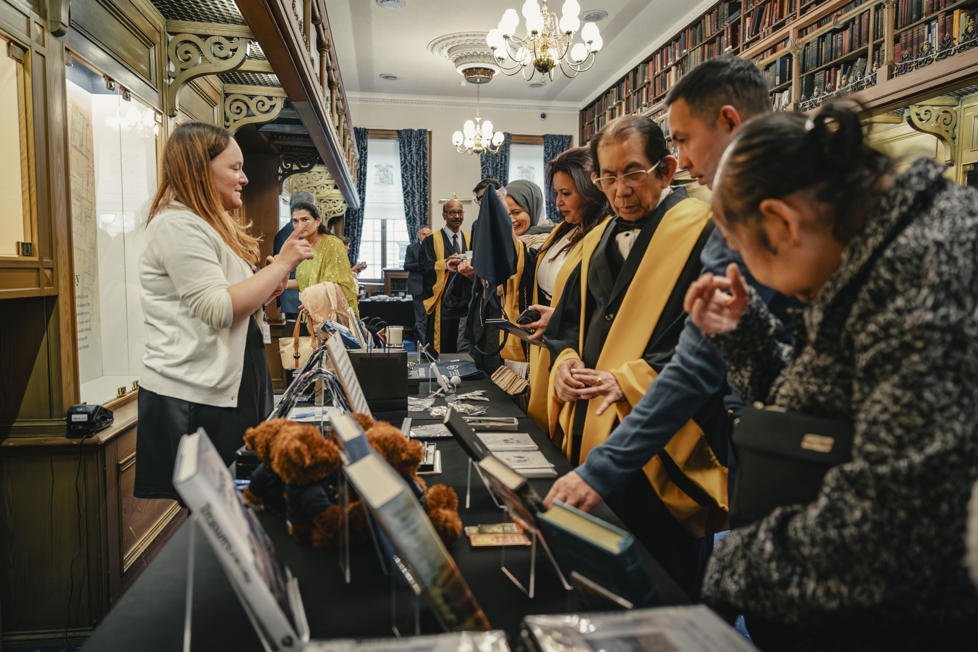 Diplomates looking at the College merch stand